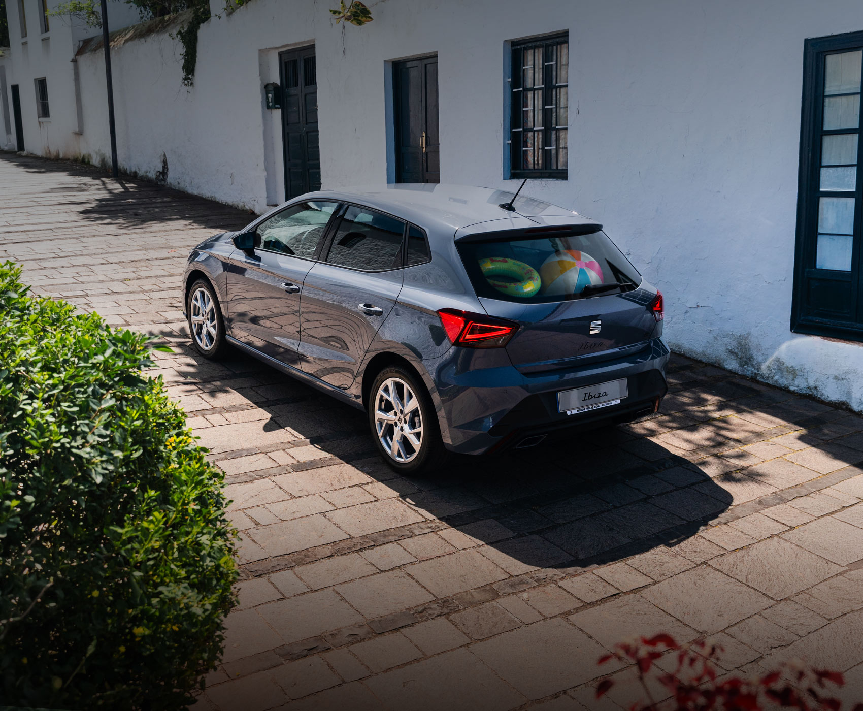 Vista completa de un SEAT Ibiza 2026 de color rojo, aparcado al aire libre